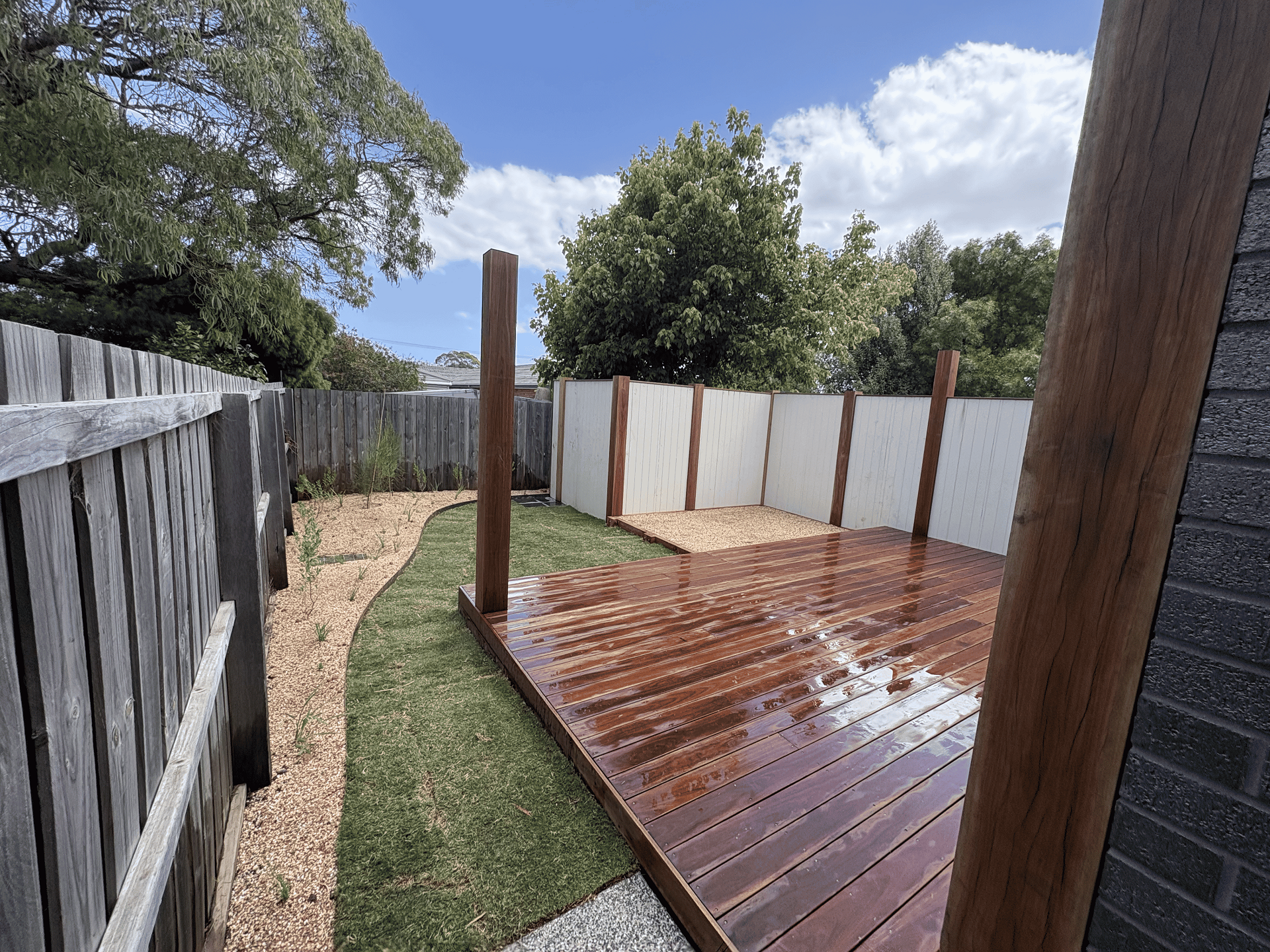 Timber decking and backyard turf landscaping in Melbourne