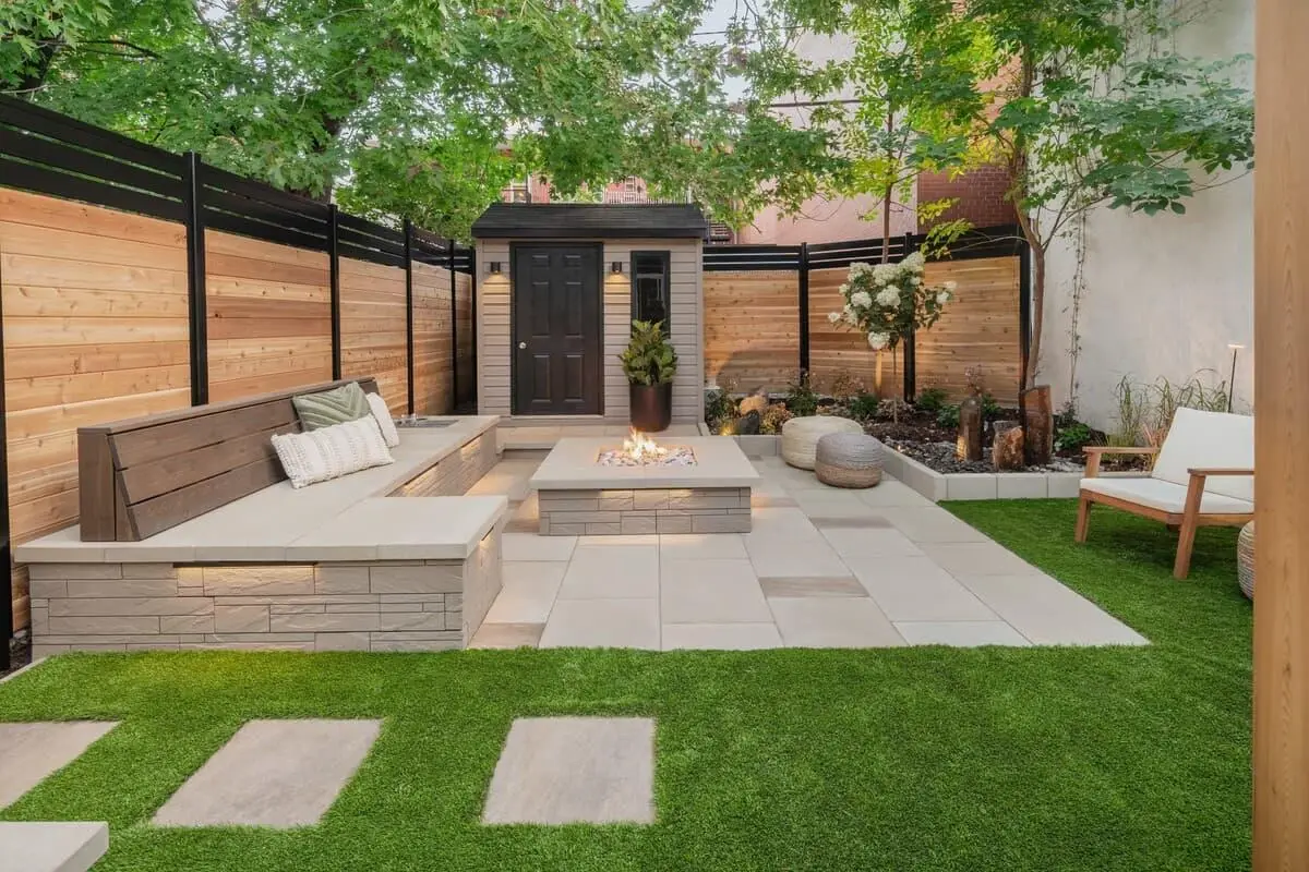 Extending residential indoor living with modern landscaped patio, built-in seating, and gas fire pit