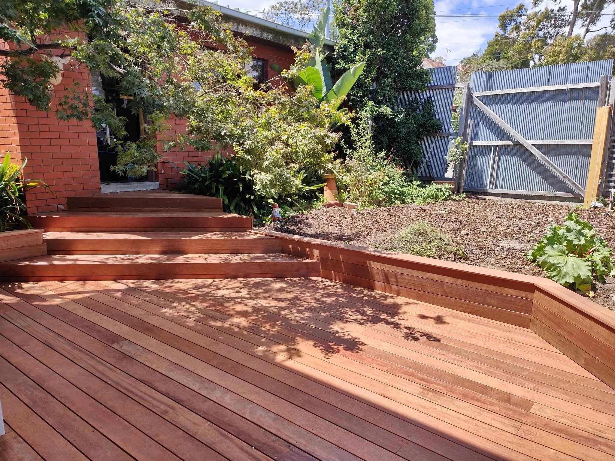 Professionally built raised timber deck integrated with a landscaped backyard